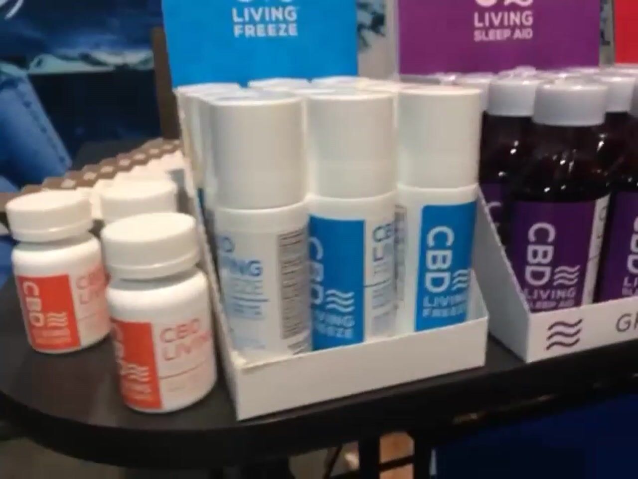 CBD Living Waters Champs Booth with SmokesModel Linda White